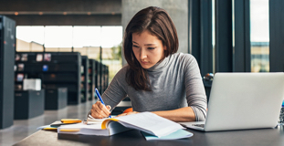 Woman researching Canadian bankruptcy laws at a library